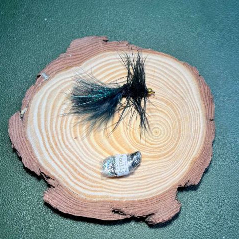 The whoop bass, famous woolly bugger on a wood disc