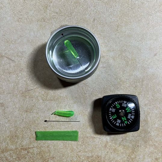 Compass and green markers on a beige surface