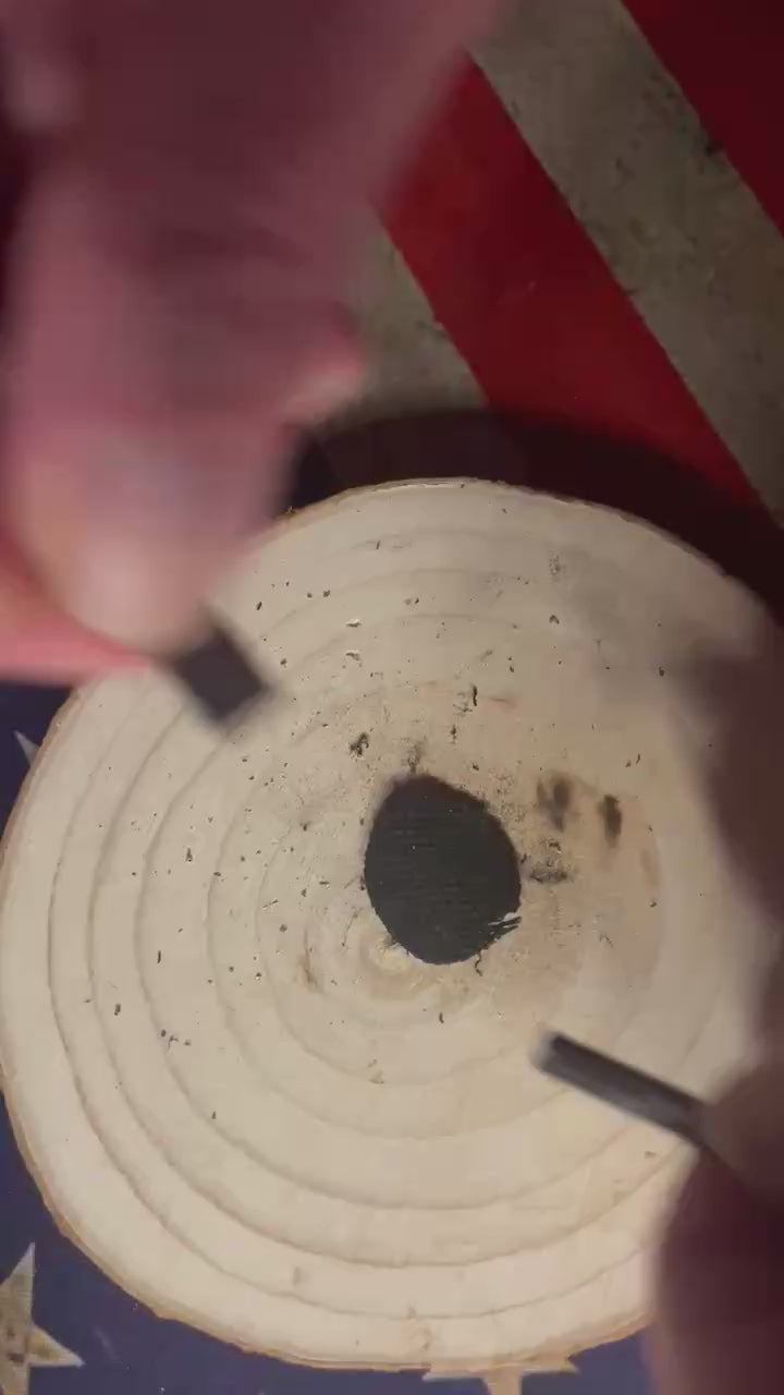 Mini ferro rod from the Tiny Can of Whoop Bass Version 2.0 striking bright sparks onto char cloth during a fire‑starting demonstration.